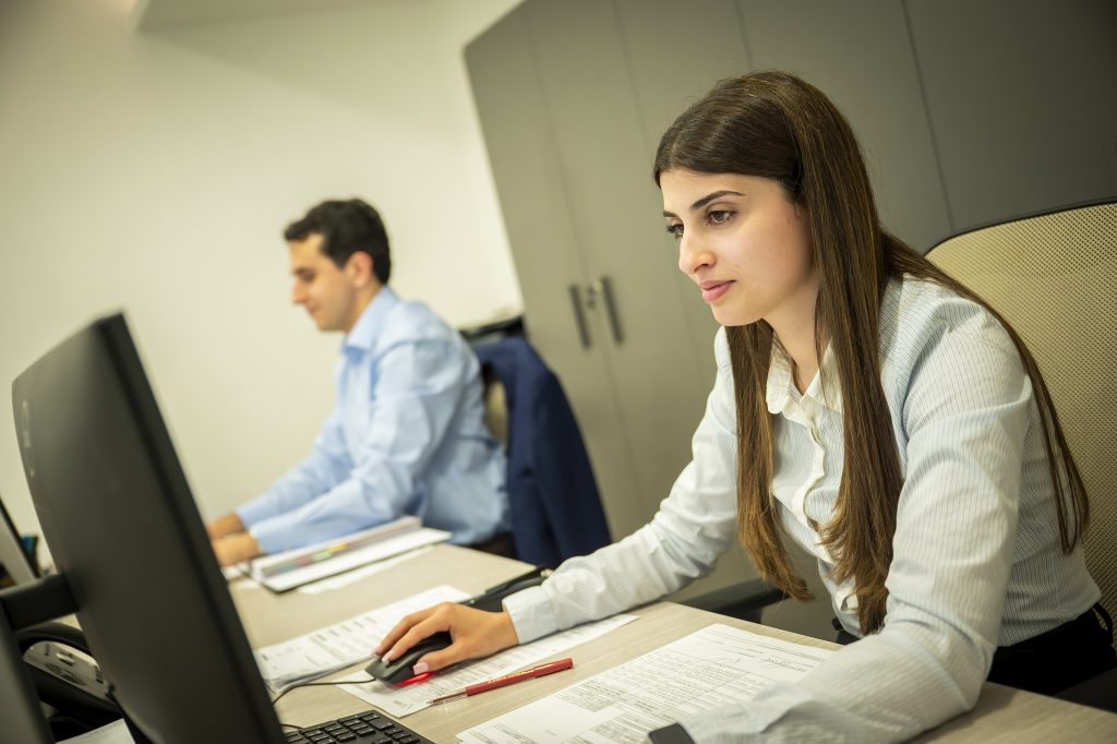 Two members of the audit team reviewing figures together